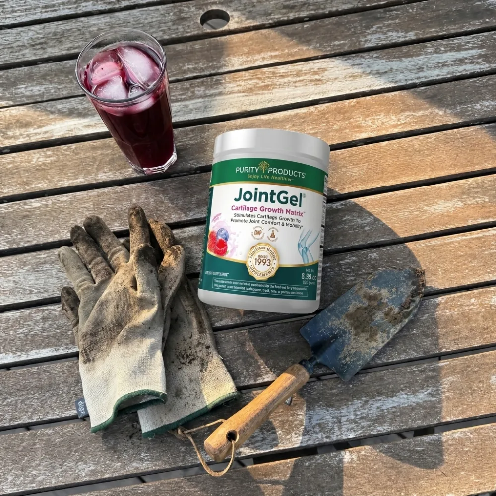 JointGel jar on a garden table with work gloves, a trowel, and a mixed berry drink over ice